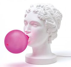 a white head with curly hair holding a pink balloon