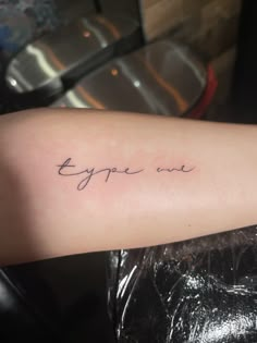 a person with a tattoo on their arm that says, eyppe me in cursive writing