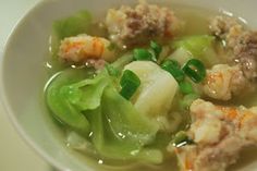 a white bowl filled with soup and vegetables