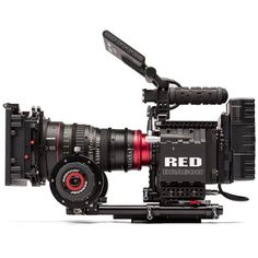 the red cinema camera on a tripod is ready to be used by someone else