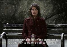 a woman sitting on a bench in the snow