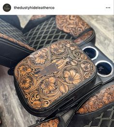 the inside of a pair of black and brown shoes with floral designs on them, sitting on top of a wooden floor