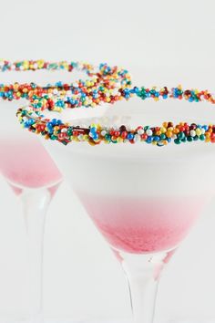 two martini glasses filled with candy and sprinkles