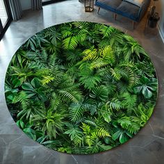 a large round rug with green leaves on it