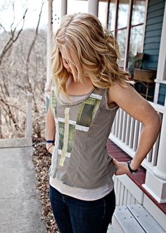 a woman standing on the porch with her back to the camera