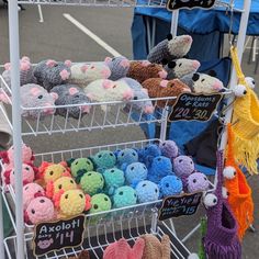 there are many stuffed animals on display at the market