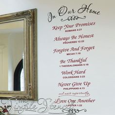 a wall with the words in our home written on it next to a framed mirror