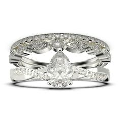 a wedding ring set with a pear shaped diamond in the center and side stones on each band