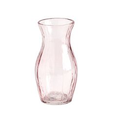 a pink vase sitting on top of a white table