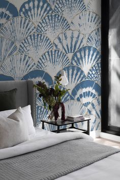 a bedroom with a large blue fan design on the wall