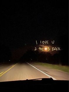 i love u 2 the b'back written in neon lights on an empty road