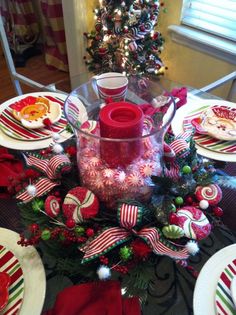 a christmas table setting with candy canes and ornaments