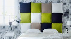 an image of a bed with pillows and blankets on it's headboard in different colors