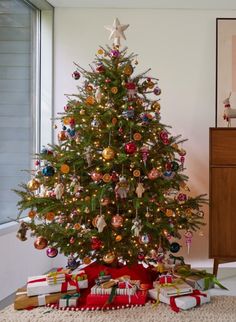 a decorated christmas tree with presents under it