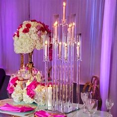 a table topped with lots of flowers and candles