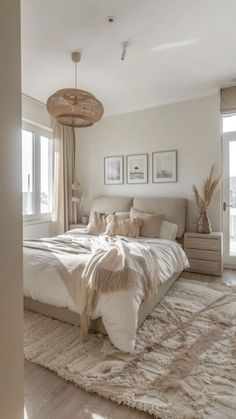 a large bed sitting in the middle of a bedroom next to a window with curtains