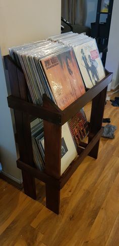 a wooden stand with many records on it