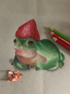 a drawing of a frog with a strawberry on it's head sitting next to two colored pencils