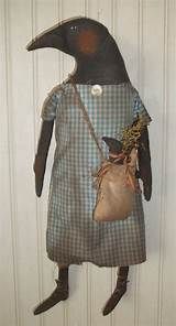 an old fashioned doll with a bag on it's back hanging from the wall