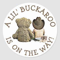 a sticker that says, all buckaro is on the way with two teddy bears