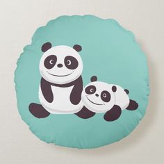 two panda bears sitting on top of a blue pillow with the same color as it is