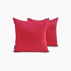 two red pillows sitting on top of each other