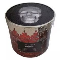 a black and white photo of a skull in a red flowered bucket with the words vampire blood written on it