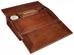 a wooden desk with two drawers and a clock on the top one drawer is open