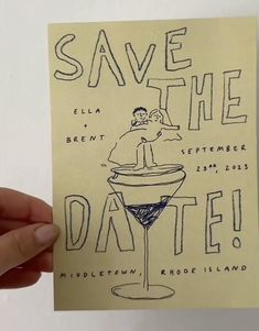 a hand holding up a piece of paper with the words save the date written on it