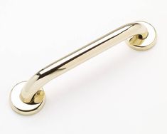 an image of a handle on a white surface with gold colored handles and round knobs