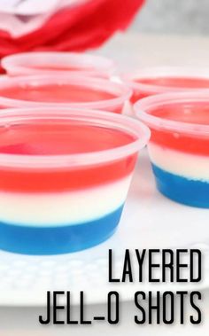 red, white and blue jell - o shots on a plate with the words layered jello shots