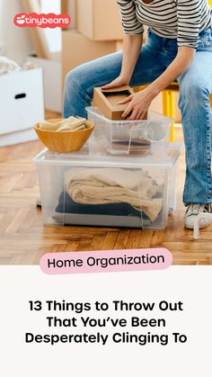 a woman sitting on top of a plastic container filled with clothes and other household items