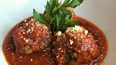 meatballs covered in sauce and garnished with parsley