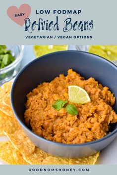 a blue bowl filled with salsa next to tortilla chips and lime wedges