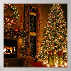 a living room decorated for christmas with lit trees and candles in front of the fireplace