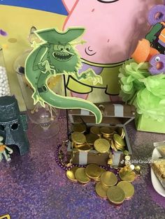 a table topped with lots of gold coins and figurines on top of it