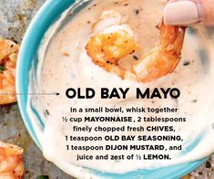 a hand dipping shrimp into a bowl of old bay mayo dip with the recipe below