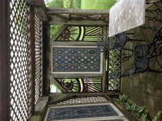 an outdoor table and chairs under a pergolated roof