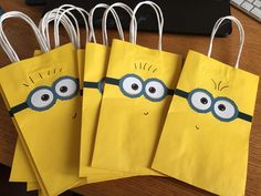 five yellow bags with eyes and ears are sitting on a desk next to a keyboard