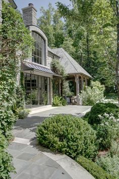 a large house surrounded by trees and bushes