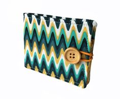 a small wallet with a button on the front and an image of a chevron pattern