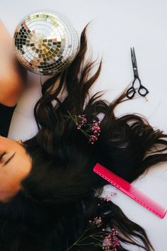 a woman laying on the floor with her hair and comb