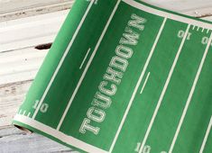 a close up of a green football field with the word wisconsin on it's side