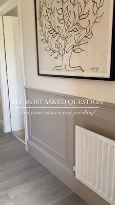 a painting hanging on the wall next to a radiator in a room with white walls