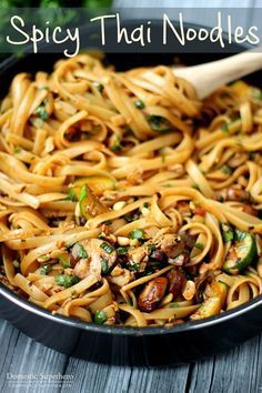 a skillet with noodles and mushrooms in it