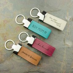 three leather key chains with name tags on them