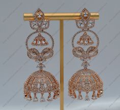 A Premium quality statement CZ Jhumkis with baguette bow. The simplicity and elegance of these earrings make it a versatile accessory that is easy to pair with any event or outfit. Length: Approx. 3" Width: Approx. 0.5" Light-weight, Push-Back closure Rose Gold finish on high-quality brass as the base metal In-stock & ready-to-ship *Color may vary slightly due to light condition & photography. Jewelry Care: Keep away from moisture. Allow perfumes and lotion to dry before wearing. Store in jewelr Elegant Cubic Zirconia Jhumkas, Elegant Cubic Zirconia Jhumkas For Formal Occasions, Cubic Zirconia Jhumkas For Celebration, Elegant Party Jhumkas With Latkans, Photography Jewelry, Base Metal, Jewelry Care, Gold Finish, Lotion