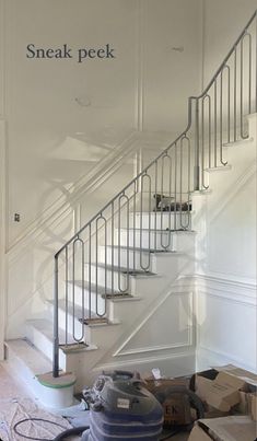 a room with some boxes on the floor and a stair case in front of it