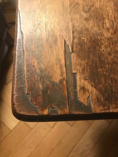 an old wooden table with peeling paint on it