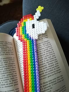 a bookmark made out of legos with a rainbow on it's side